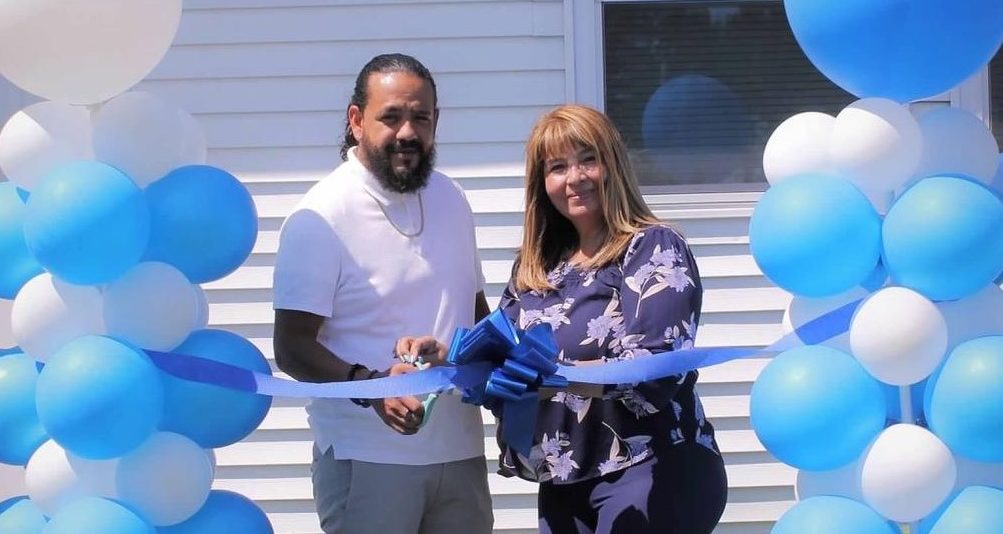 Businesswoman opening Central Islip insurance agency